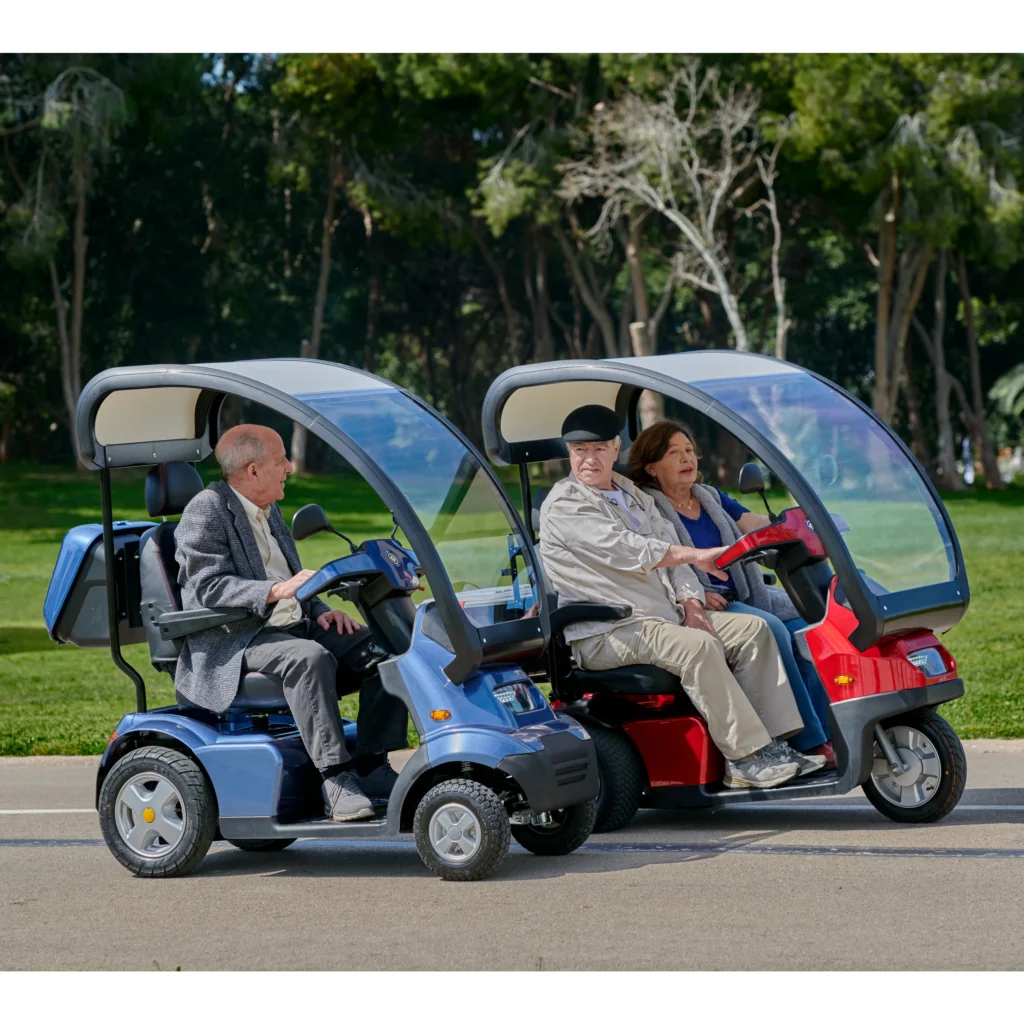 Lifestyle Image Side View of Blue Afiscooter S4 with Canopy Mobility Scooter, Red Afiscooter S3 Dual Seat Mobility Scooter with Canopy Golf Tires