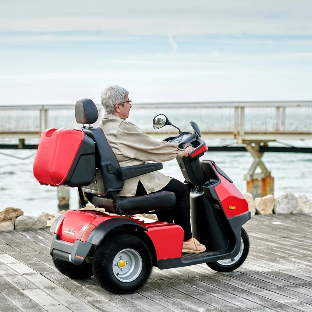 Back side view of Red Afiscooter S3 Off-road in beach side lifestyle image