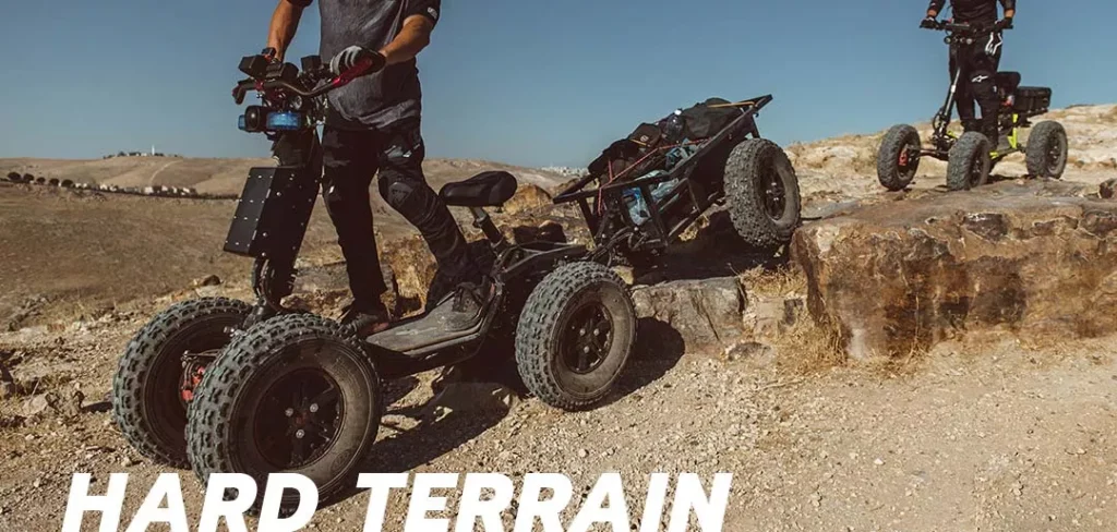 Riders using EZRaider HD4 4x4 off-road electric scooters climbing rocky terrain under clear blue sky
