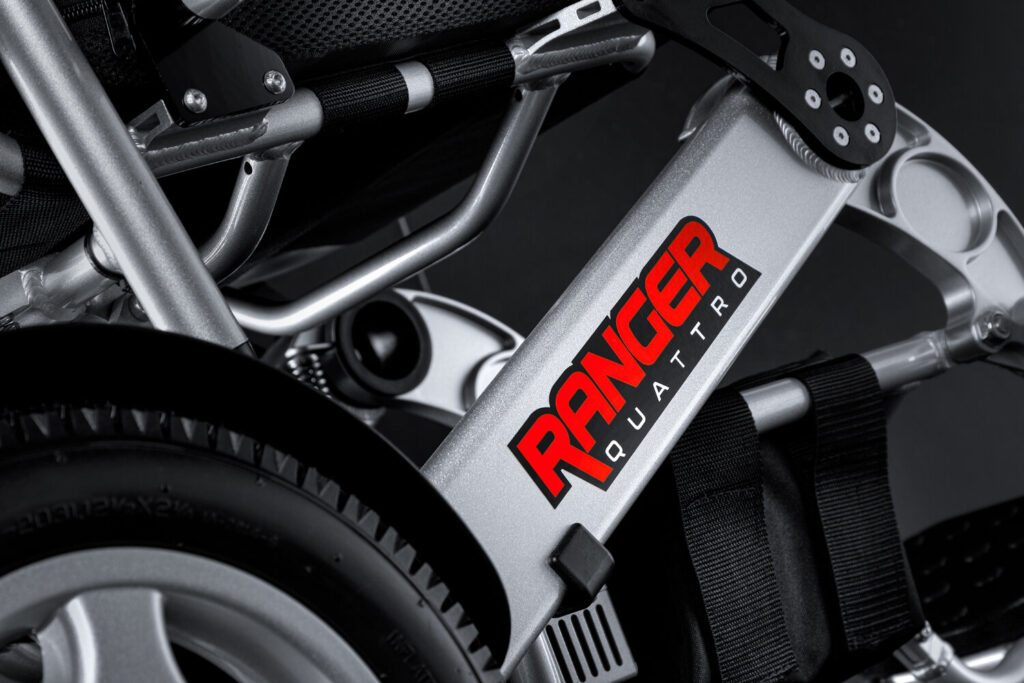 Porto Mobility Ranger Quattro XL folding power wheelchair, frame logo close up