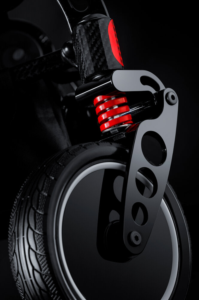 Porto Mobility Ranger SpacePro folding power wheelchair, front caster with red spring